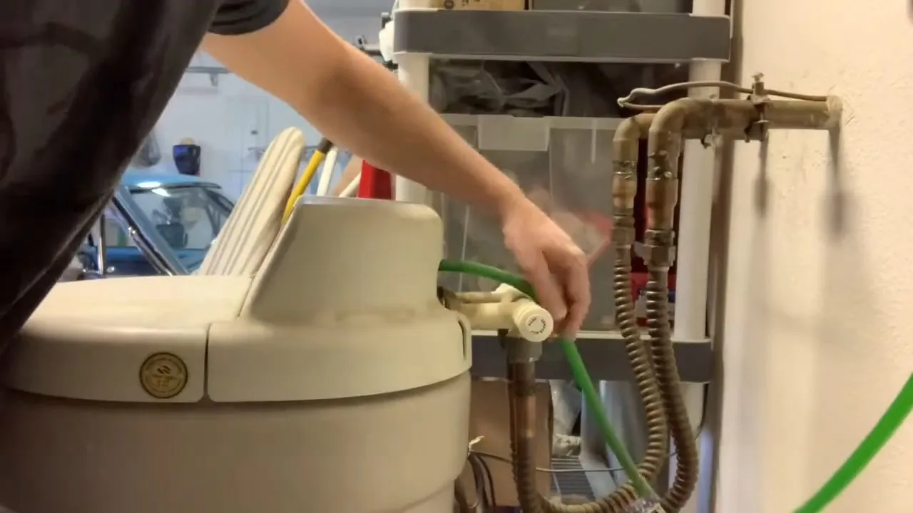 Opening water softener tank for replacement, documented during choosing a filtration system service in the Chapel Hill area