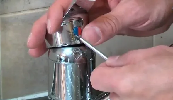Close view of removing faucet cartridge retaining screw handled during a garbage disposal do's & don'ts appointment