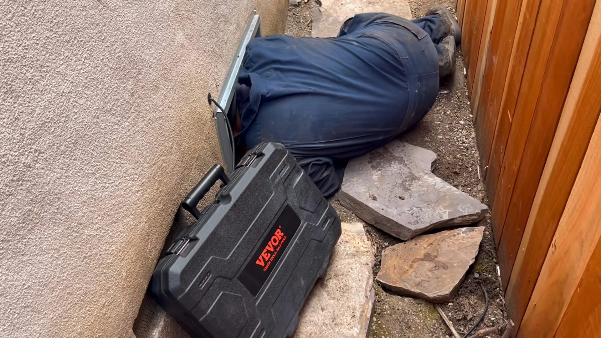 Plumber searching crawlspace for leak photographed on site during gas appliance safety basics work