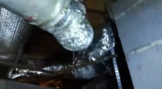 On-site detail: damaged crawlspace metal pipe close up, from a local shutting off your water main service call