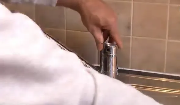 Testing repaired single handle kitchen faucet photographed on site during low water pressure causes work