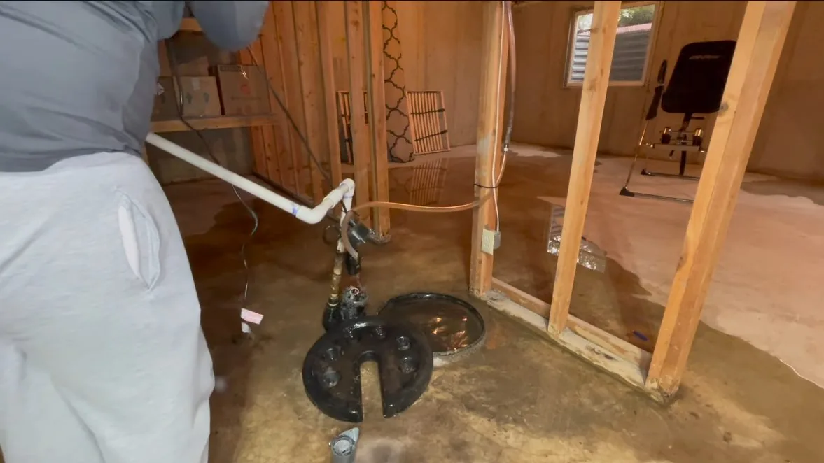 Sump pump standing in basement rough in captured mid-repair on a Chapel Hill preventing frozen pipes job