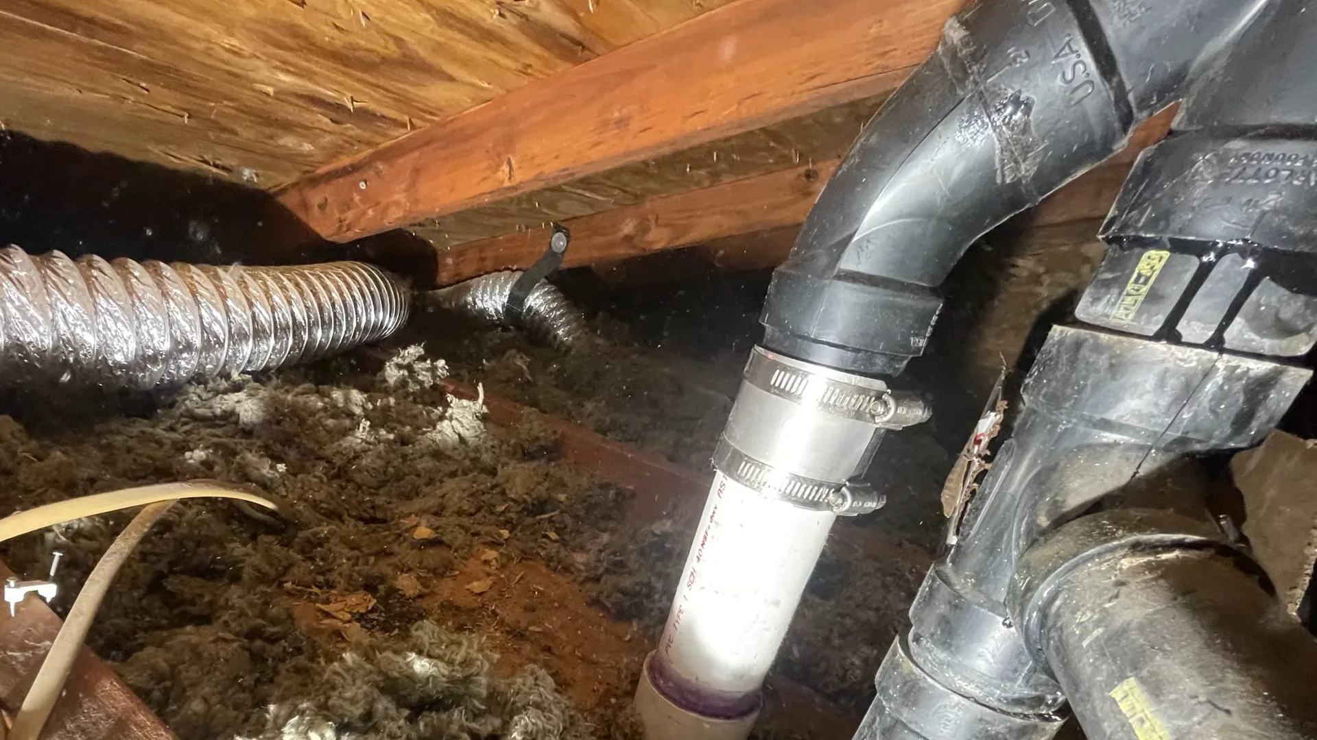 A technician working on basement drain vent pipe under floor during a sewer camera inspection explained call near Chapel Hill