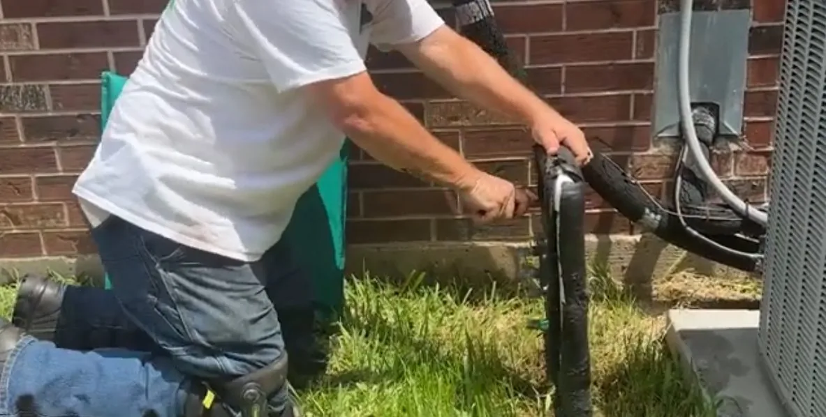 On-site detail: plumber opening backflow test port, from a local well water maintenance service call