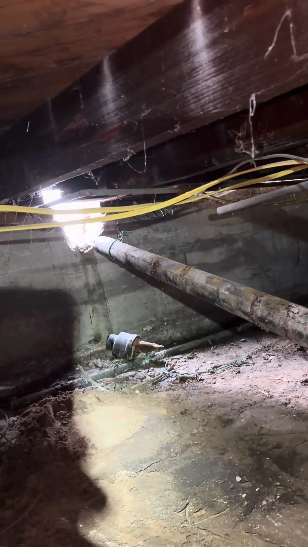 A look at plumber crawling through low clearance space from a recent Chapel Hill plumbing visit