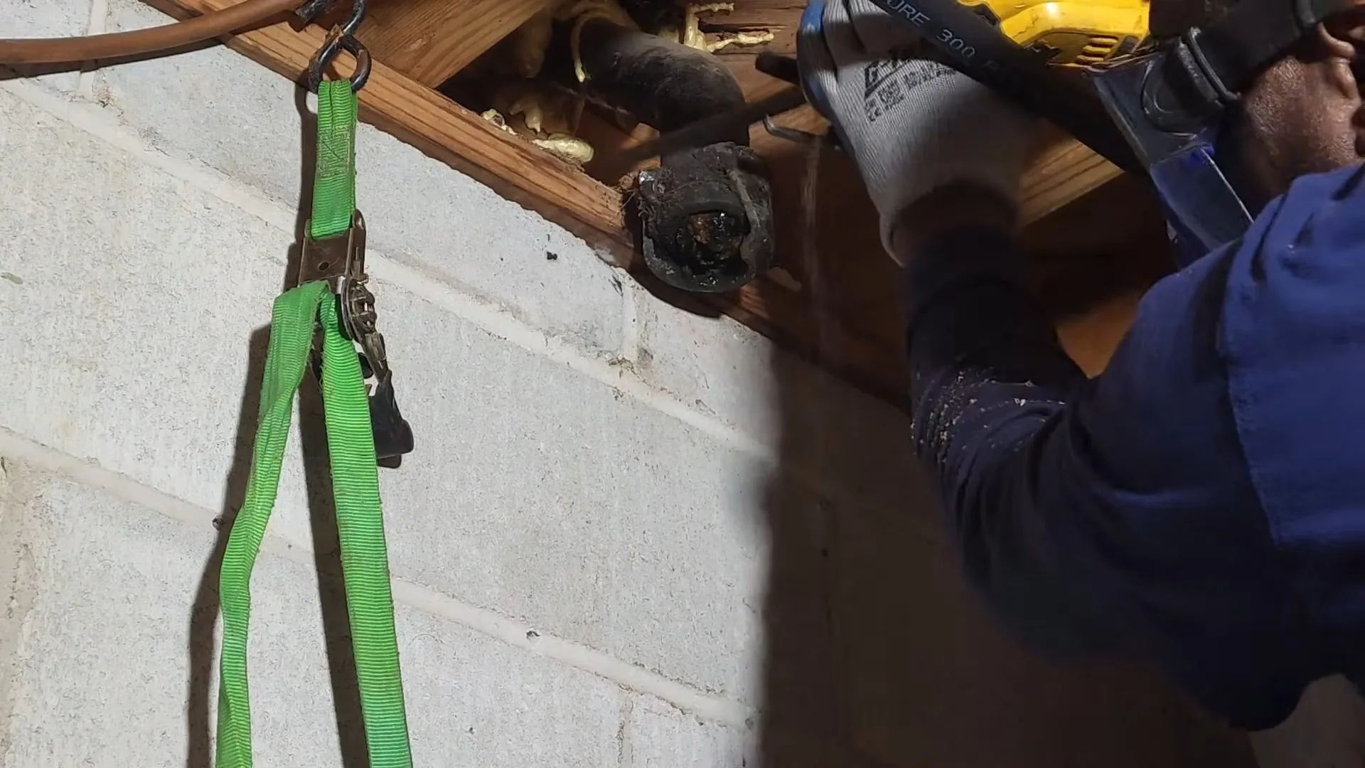 Plumber cutting exposed cast iron pipe captured mid-repair on a Chapel Hill Chapel Hill plumbing job